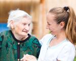 elderly lady smiling with her carer