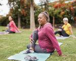People doing yoga in a park