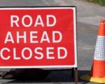 Picture of a sign saying road ahead closed