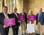 Group leaders stood holding Fair Deal for North Somerset signs