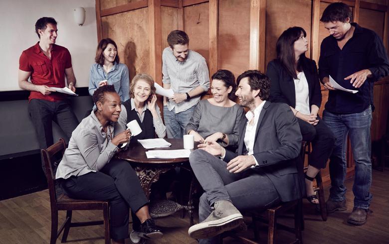 The cast of the TV series Broadchurch gather together around a table and are talking and laughing and drinking coffee