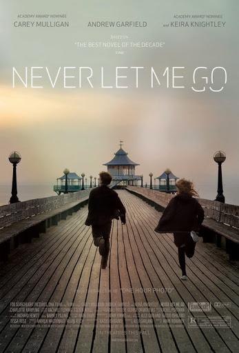 A young boy and girl run down the length of Clevedon Pier, with the pagoda in the distance