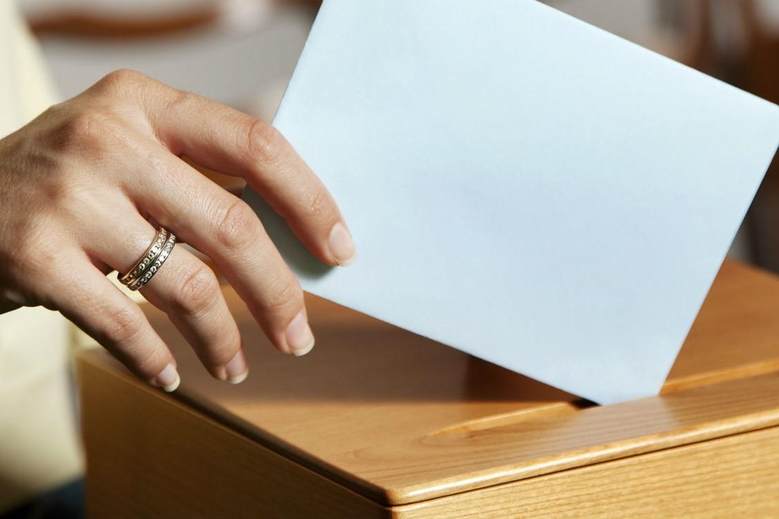 polling card being placed into ballot box