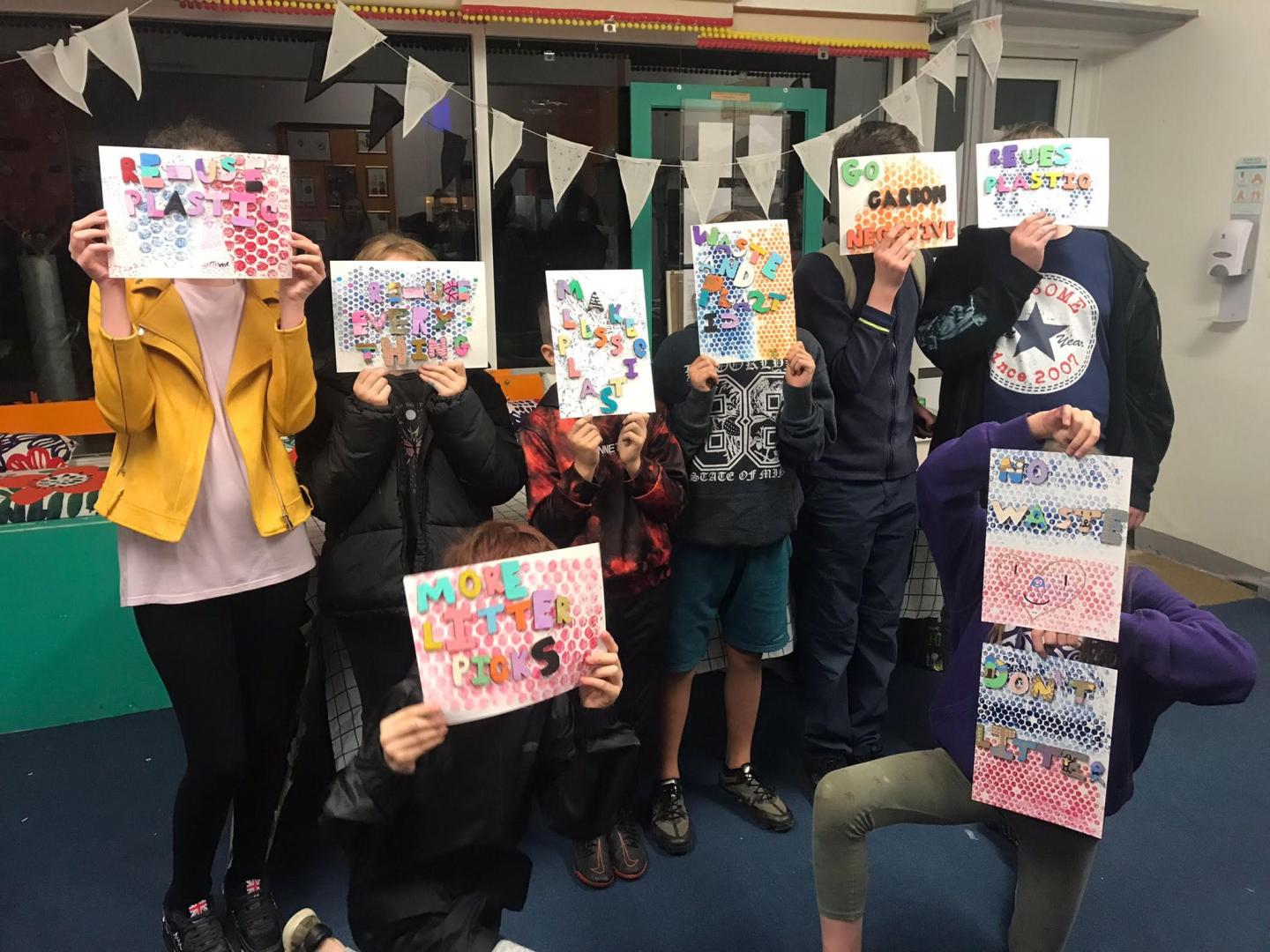 Photo of seven young people holding up the artworks they created at a Picture This workshop