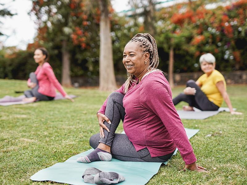 People doing yoga in a park