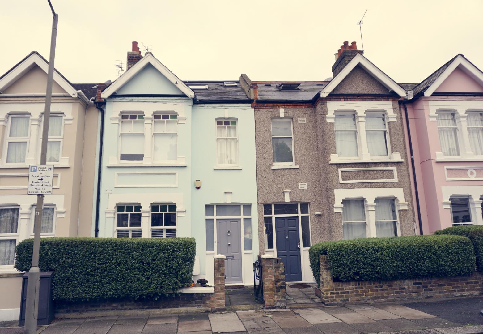 Terraced housing with varying rendering styles and pitched roofs