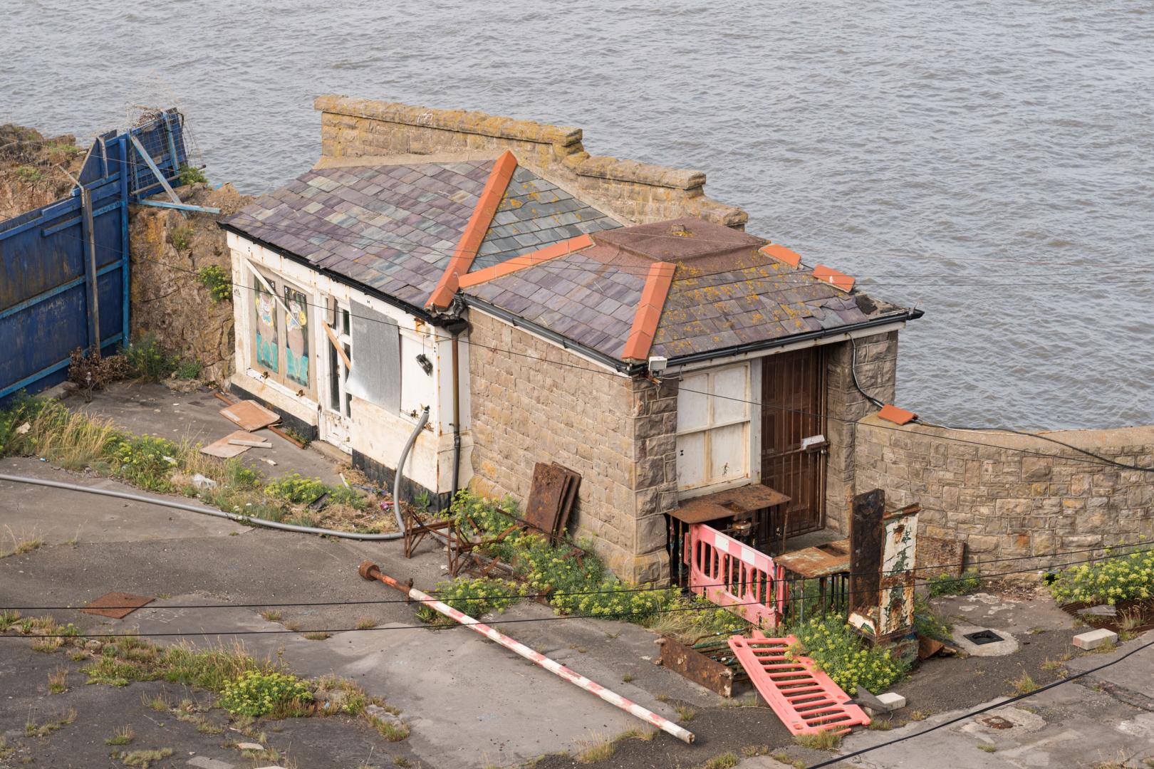 A photo of the derelict southern Toll House at Birnbeck Pier taken in August 2025. Credit © Historic England Archive