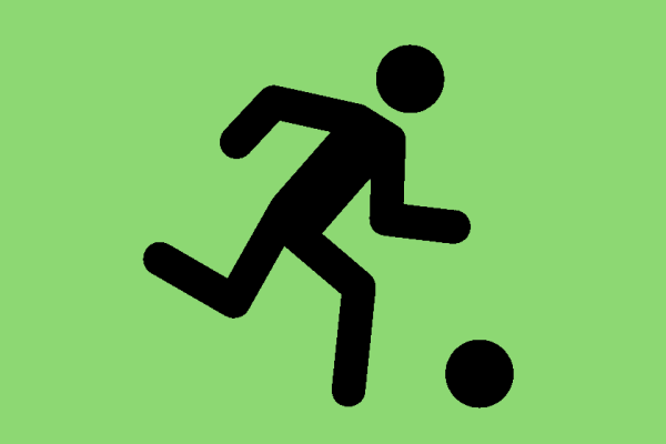 Black stick person kicking a football on a green background.