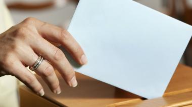 polling card being placed into ballot box