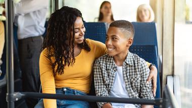 Mother and son sitting on a bus